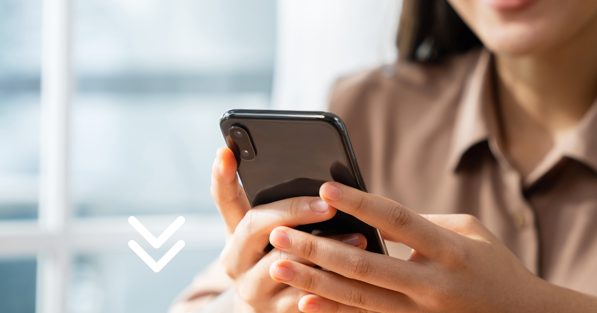 A person holding a smartphone and looking at the screen.